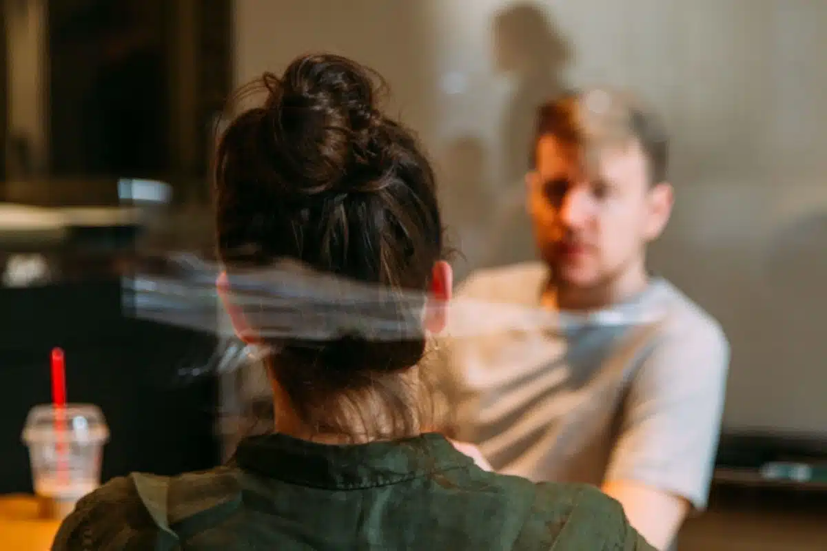 woman sitting across a table from a man