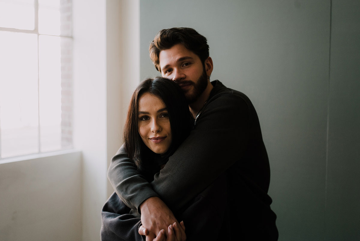 Man hugging woman from behind