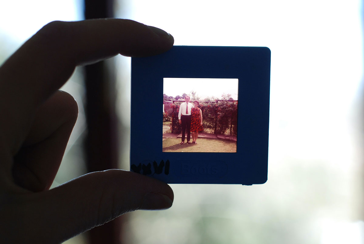 Hands holding picture of a couple