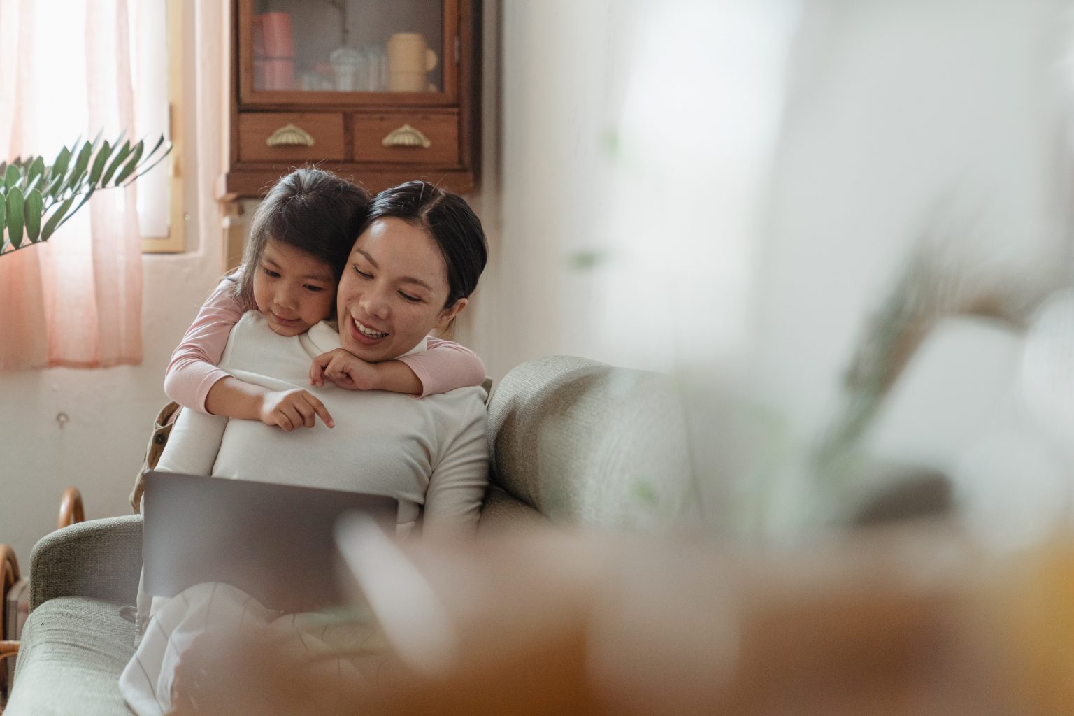 child hugging mother from behind