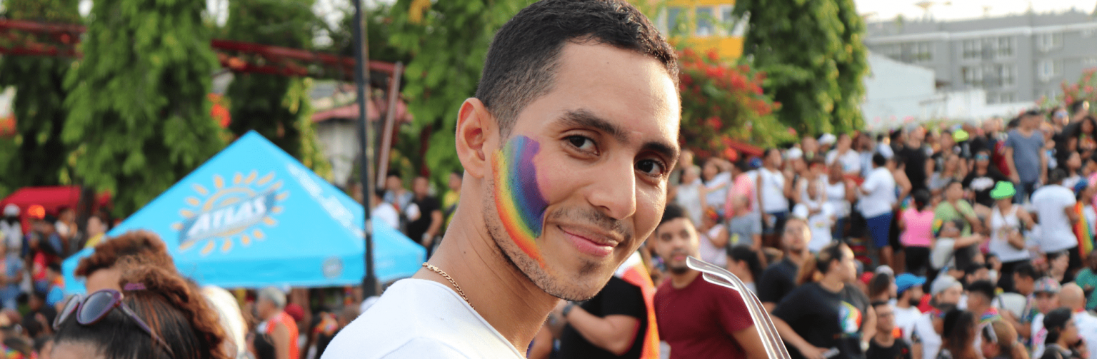 Pride parade made with rainbow painted cheek facing the camera