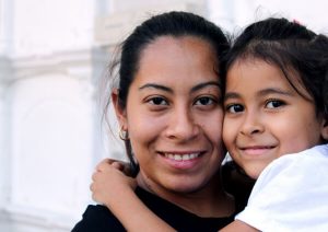 Mother and daughter smiling.