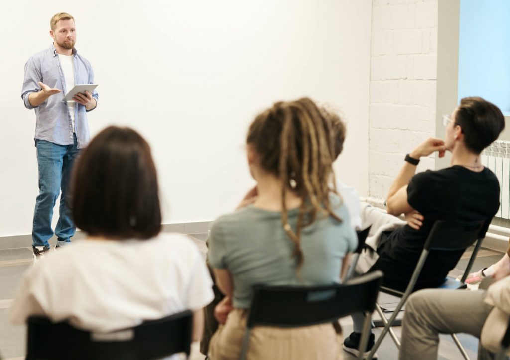 Person talking to a group of people.