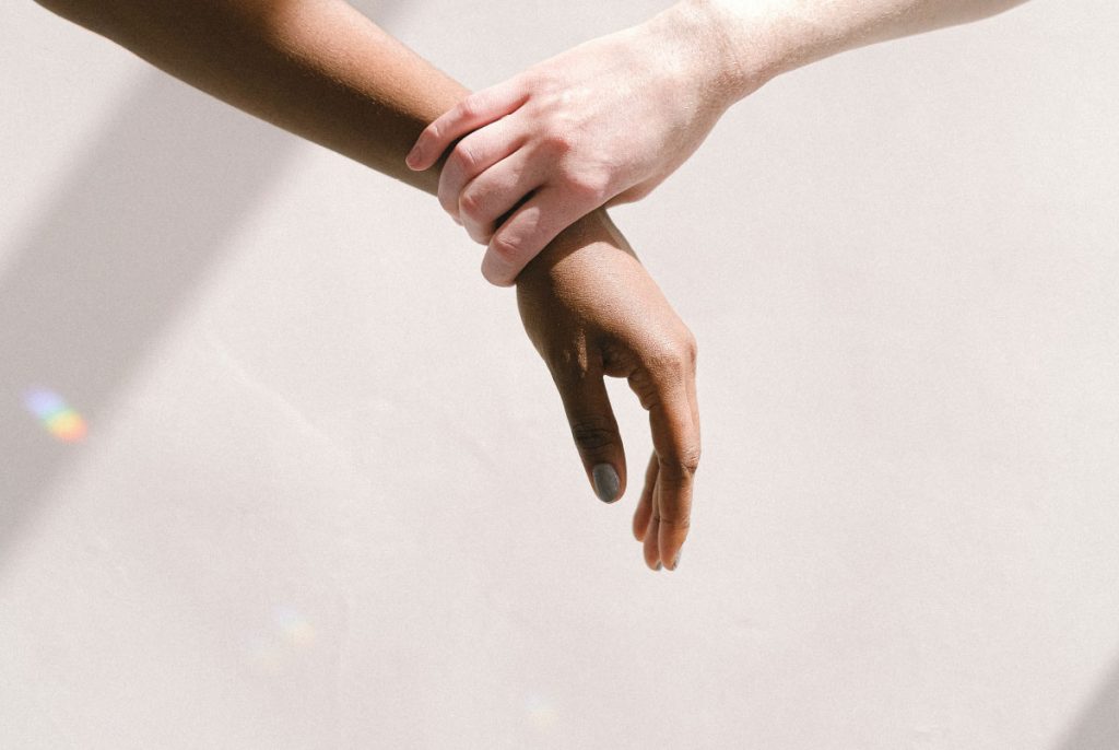 A person holding another person's wrist.
