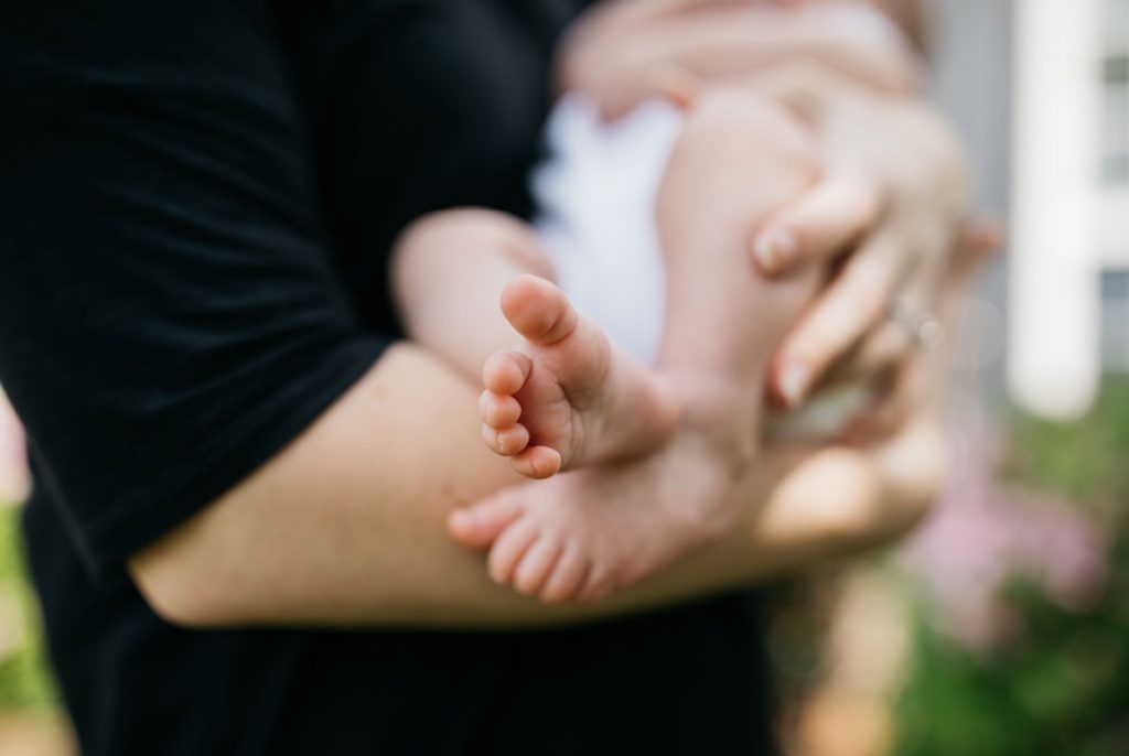 A person holding a baby in their arms.
