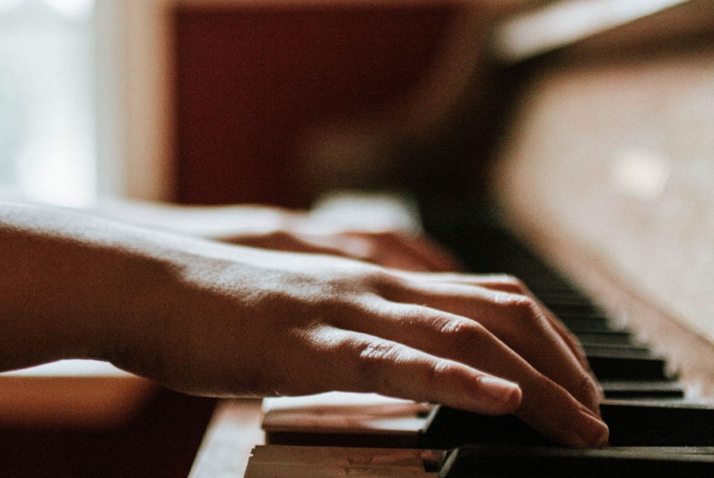 Hands playing piano.