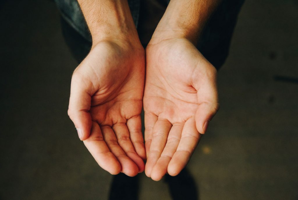 A pair of hands cupped together with upturned palms.