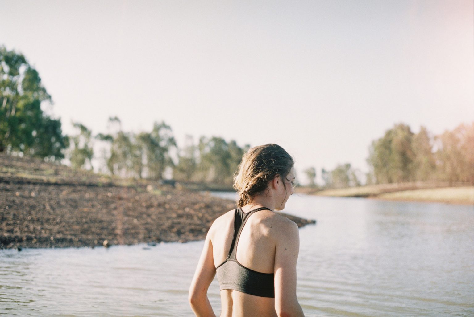 Woman wearing sports top overlooking a river