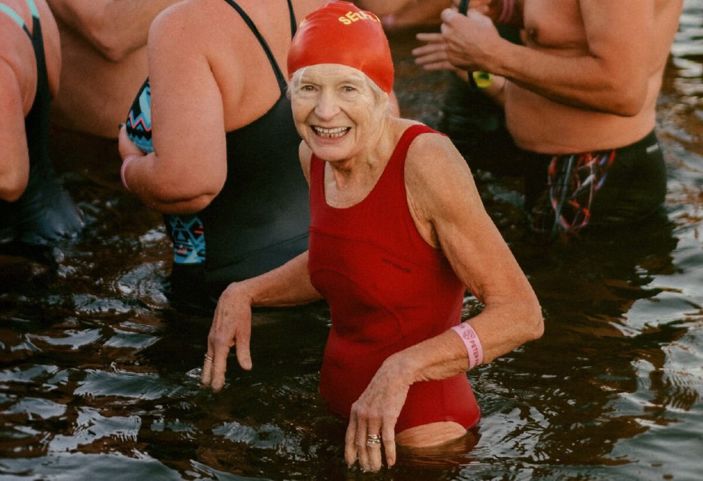 Elderly lady about to start a ocean swim race.