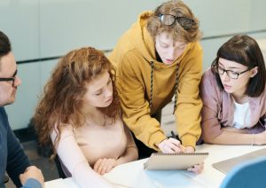 Group of people looking at a paper together.