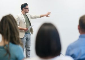 Person talking to a group of people.