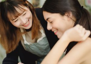 Two women talking at work.