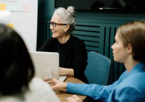 Women talking in office space.