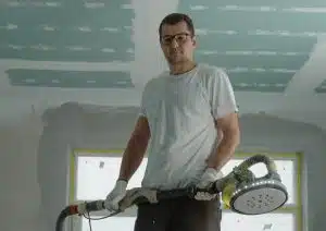 Man working on ceiling plaster.