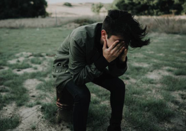 Child kneeling down crying.