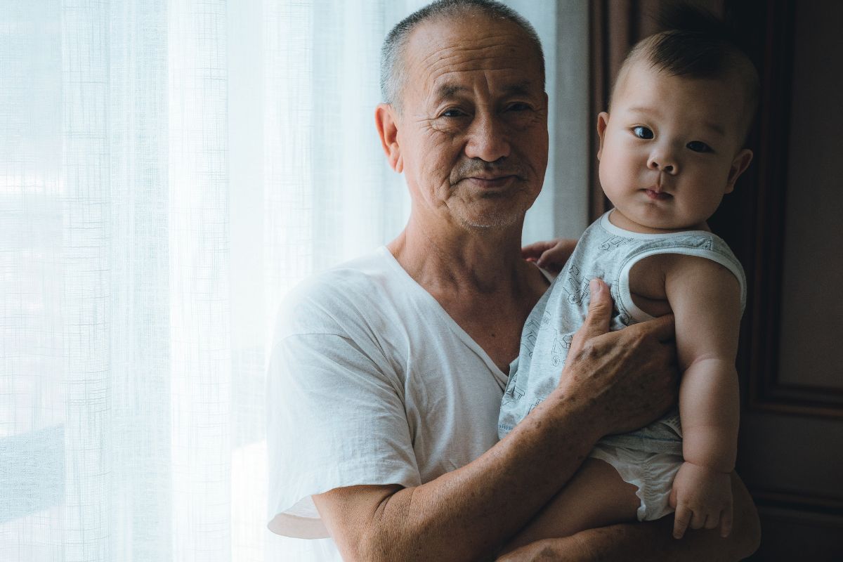Granddad holding his granddaughter and smiling
