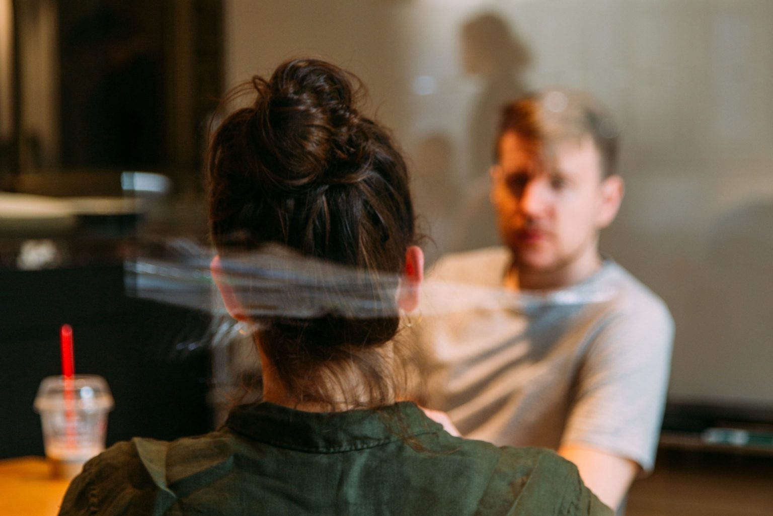 woman sitting across a table from a man