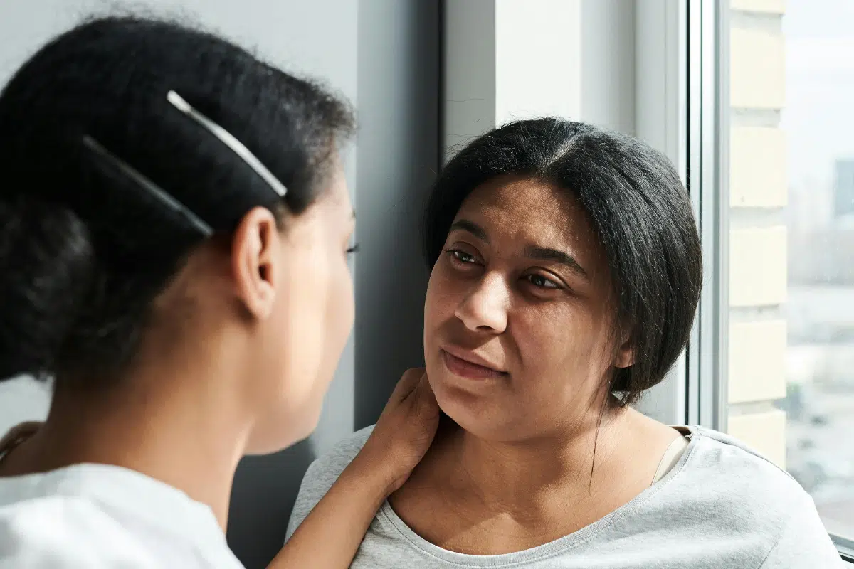 couple looking at each other near window