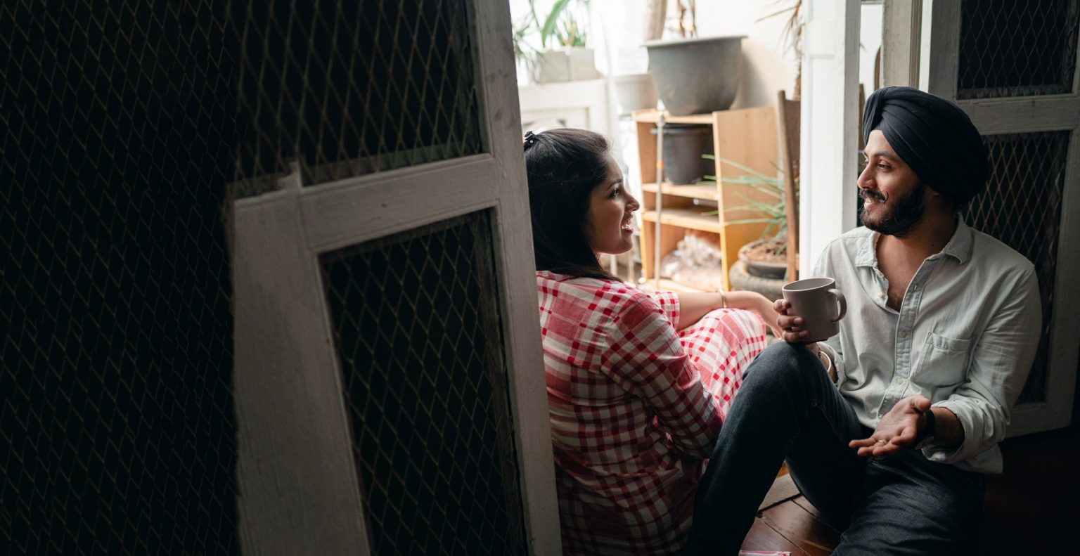 Man conversing with woman while sitting and looking at one another