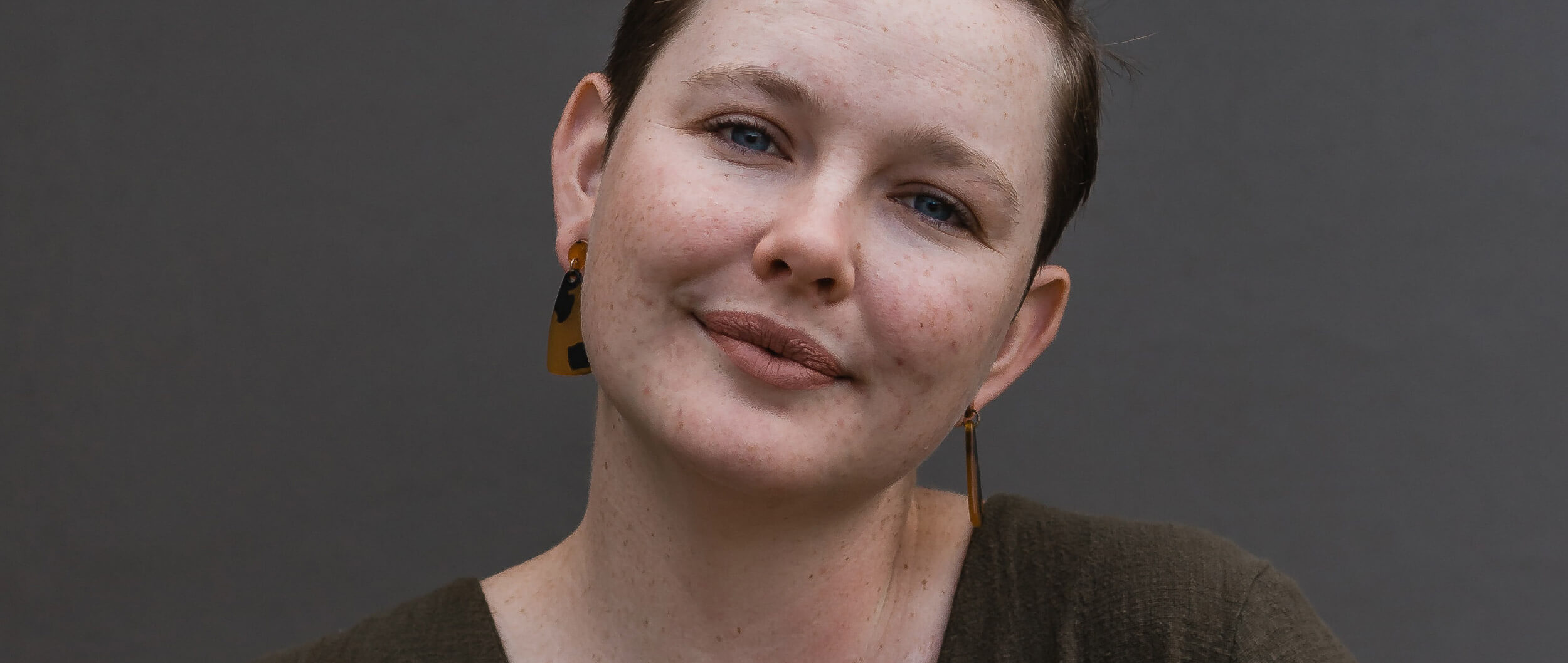 Woman looking to camera with head slightly tilted.