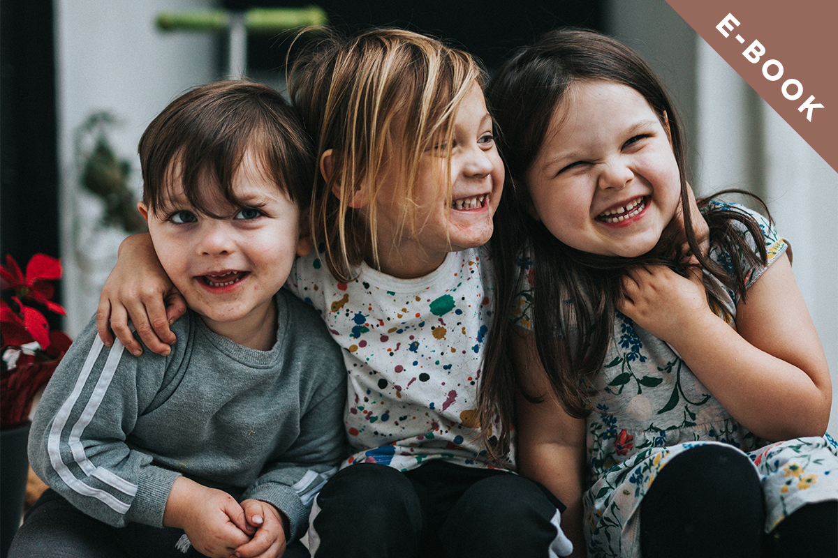 Three children smiling together