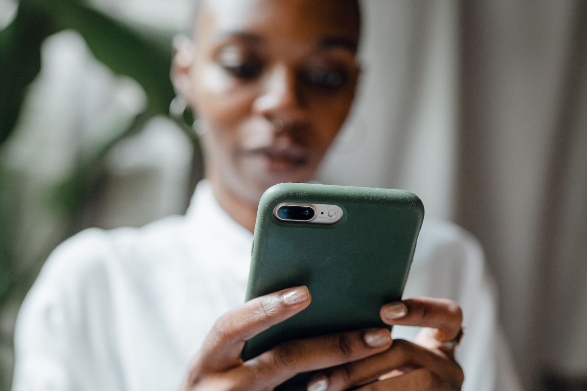 Woman typing on and looking at her phone