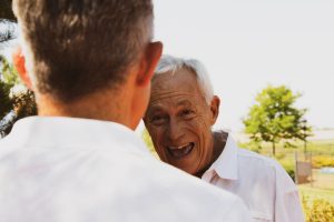 Older man laughing with his son