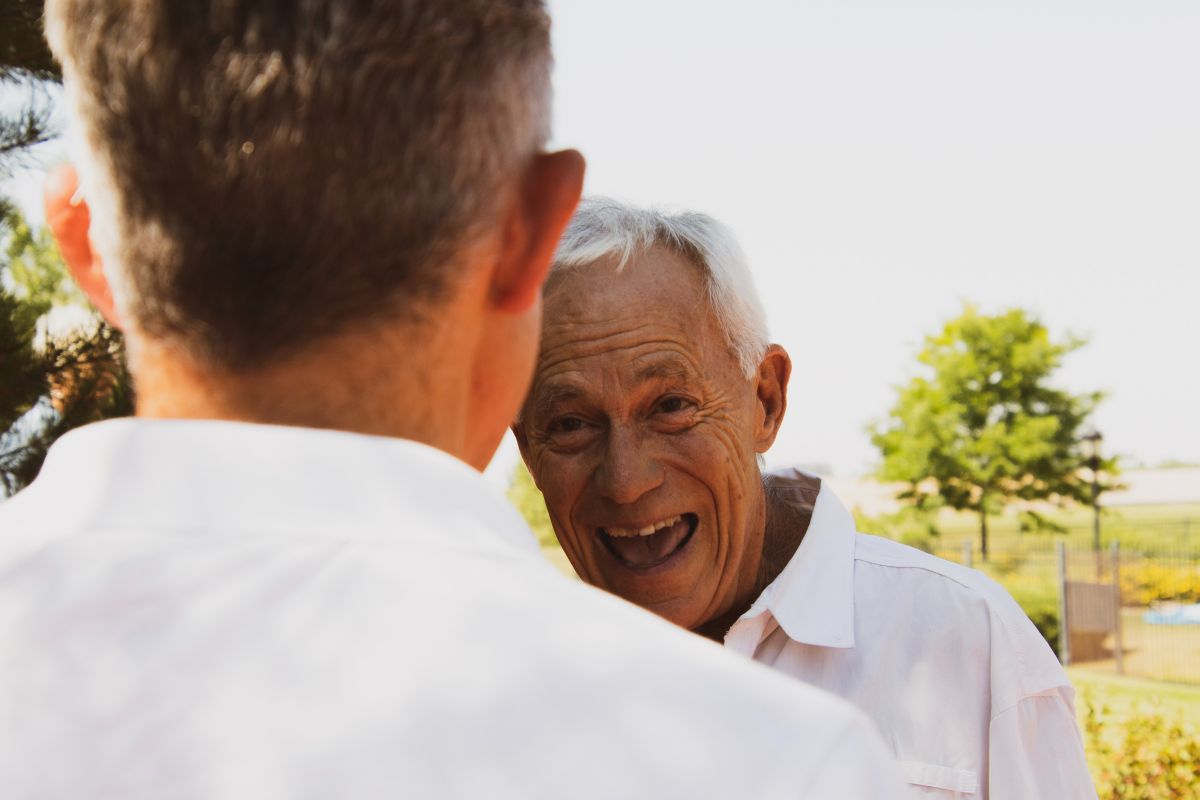 Older man laughing with his son