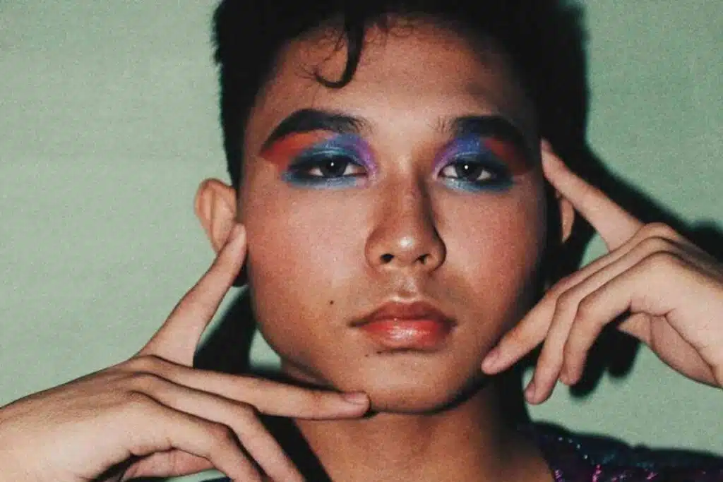 Close up of person's face wearing multicoloured eyeshadow