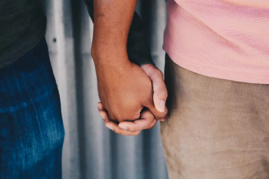 Two people holding hands, closeup