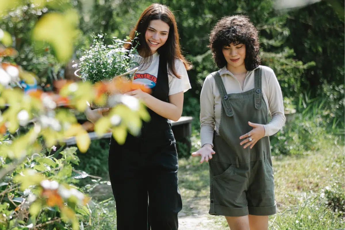 Two friends walking through a garden together.