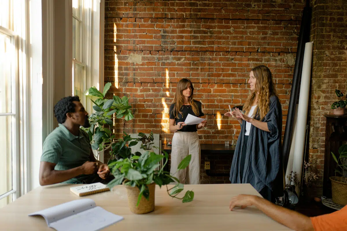 three people talking in an office space