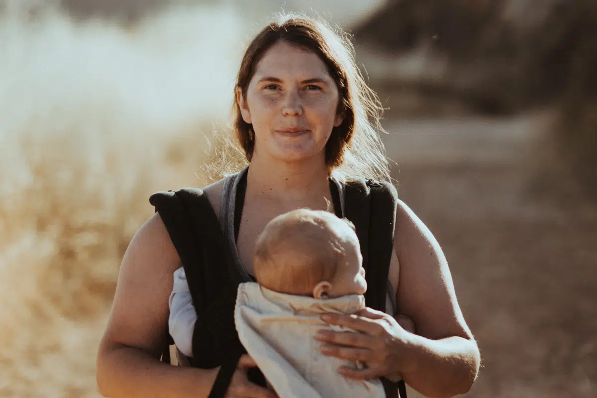 Mother carrying baby