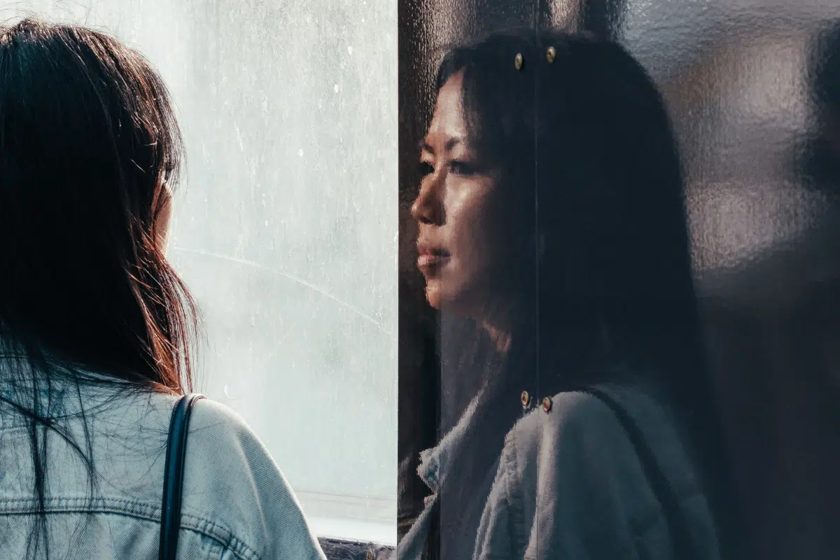 Woman's reflection in window