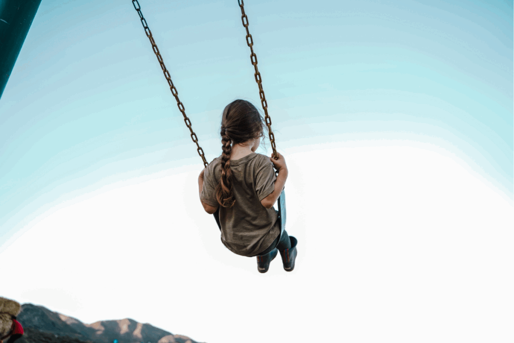 little girl on a swing