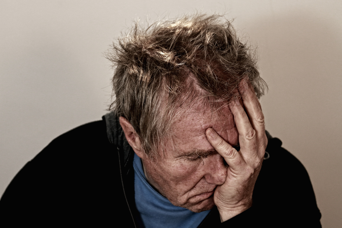 man with head in hands