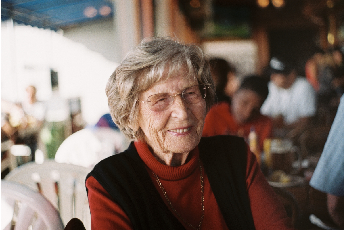 older woman smiling looking to the side