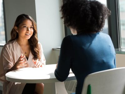 Two women talking to each other.