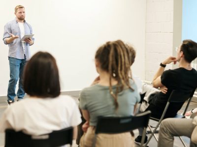 Person talking to a group of people.